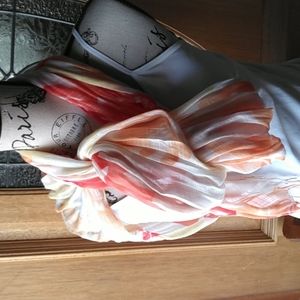Scarf in lovely floral colors of coral/peach/orange with fringe